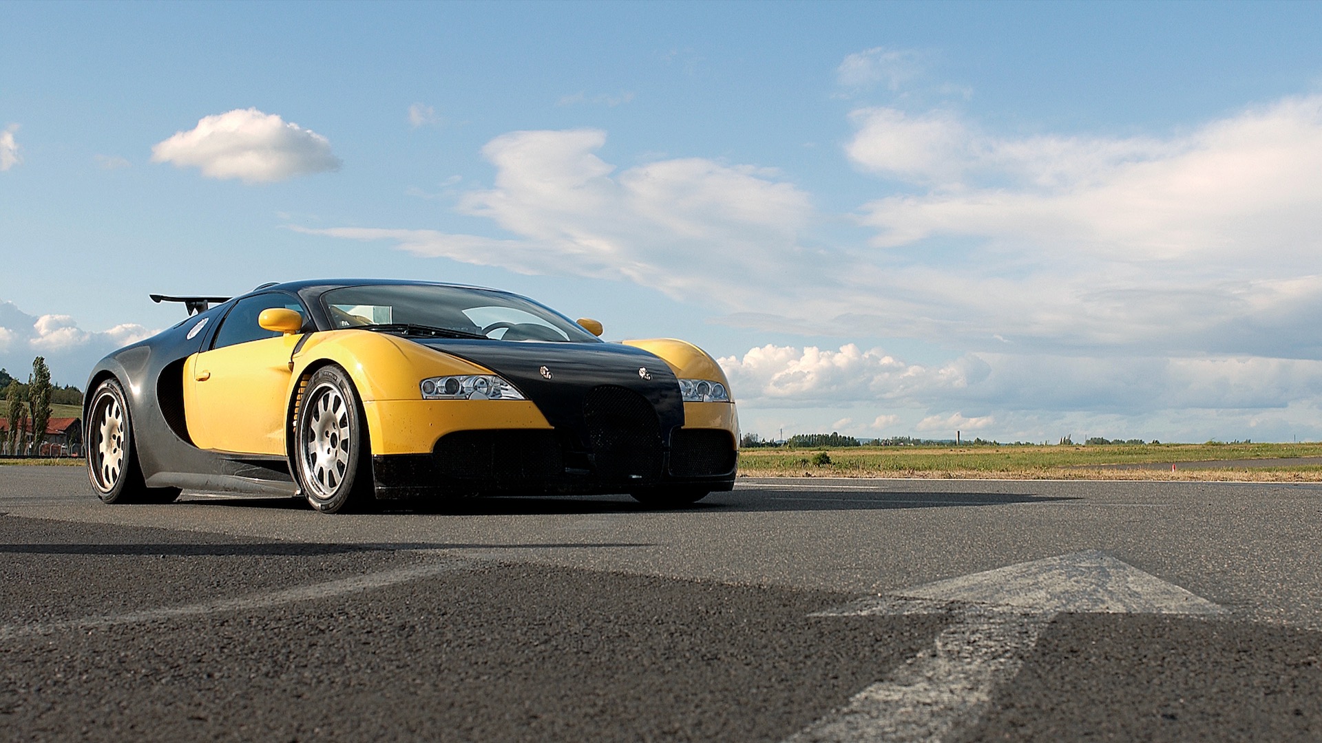A yellow and black Bugatti Veyron prototype.