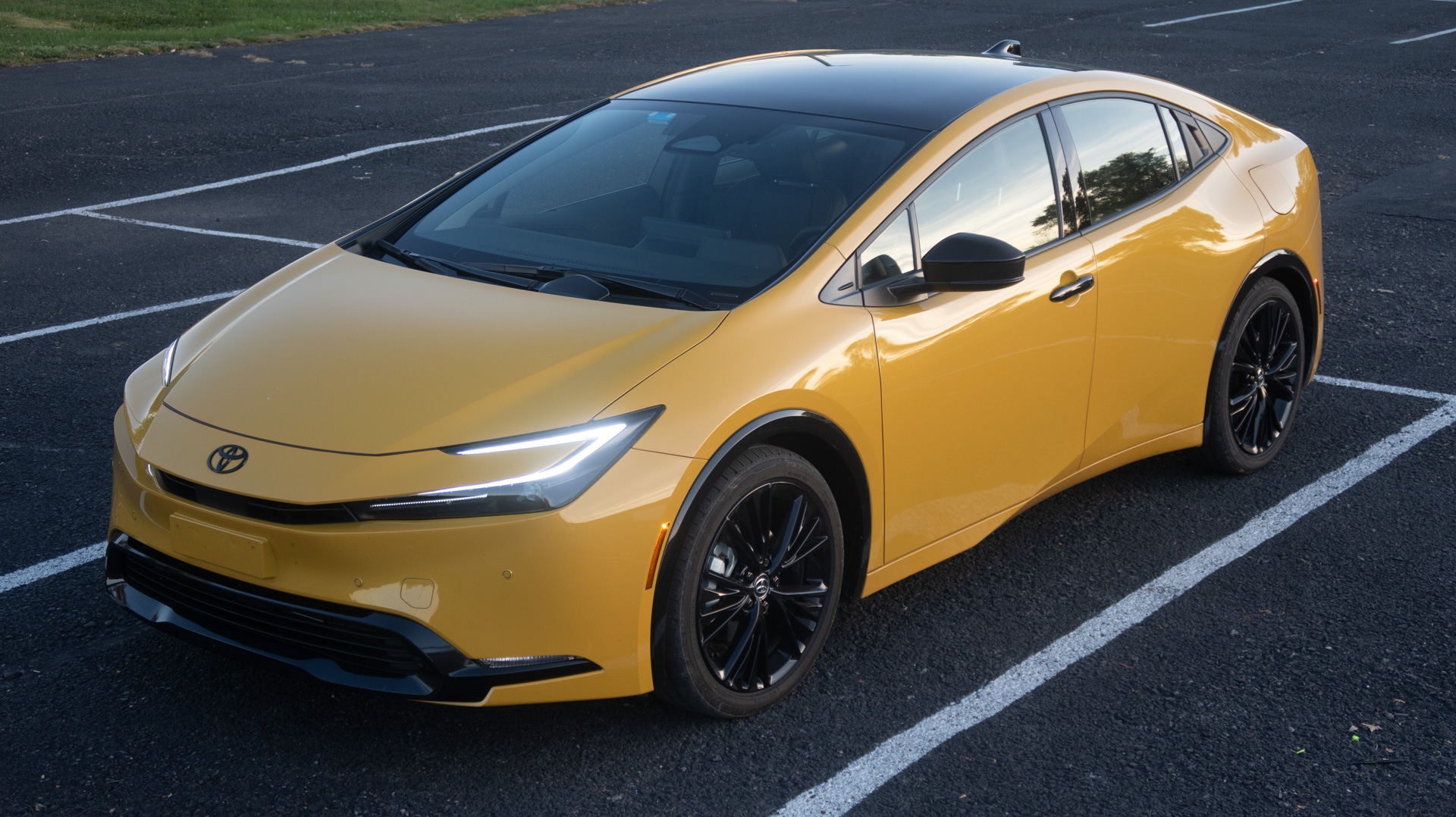 Yellow Prius from the front three-quarter (high-angle).