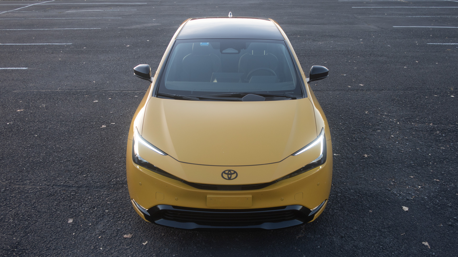 Yellow Prius from the front, high-angle.