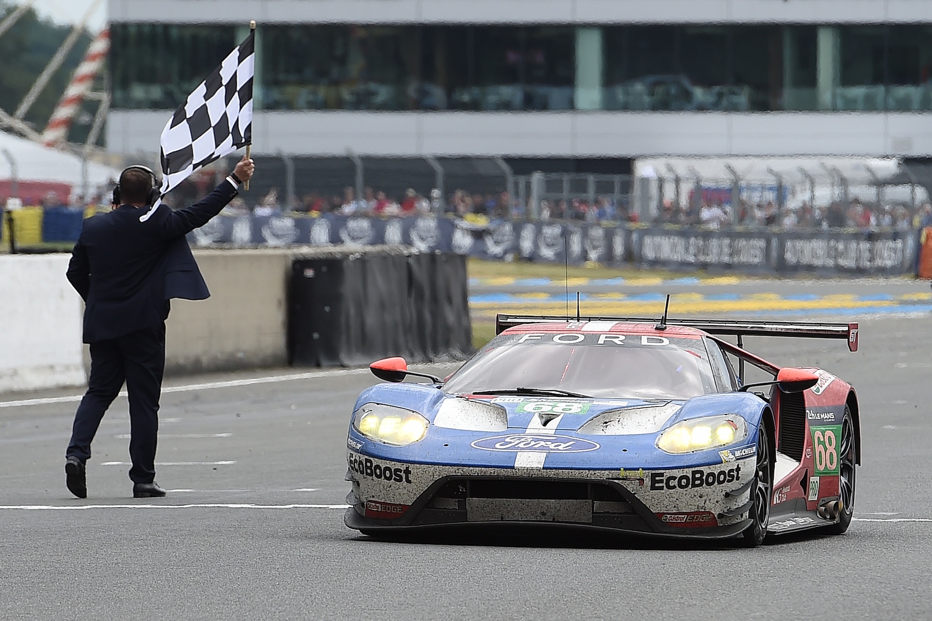 Germany's Dirk Mueller crosses the finish line on his Ford GT n°68, to win the LMGTE PRO category of the 84th Le Mans 24-hours endurance race, on June 19, 2016 in Le Mans, western France. Porsche snatched their 18th Le Mans 24 Hour Race victory with the Porsche 919 Hybrid N°2 in the most dramatic of circumstances after Toyota suffered engine failure with just three minutes left on June 19, 2016. / AFP / JEAN-SEBASTIEN EVRARD (Photo credit should read JEAN-SEBASTIEN EVRARD/AFP via Getty Images)