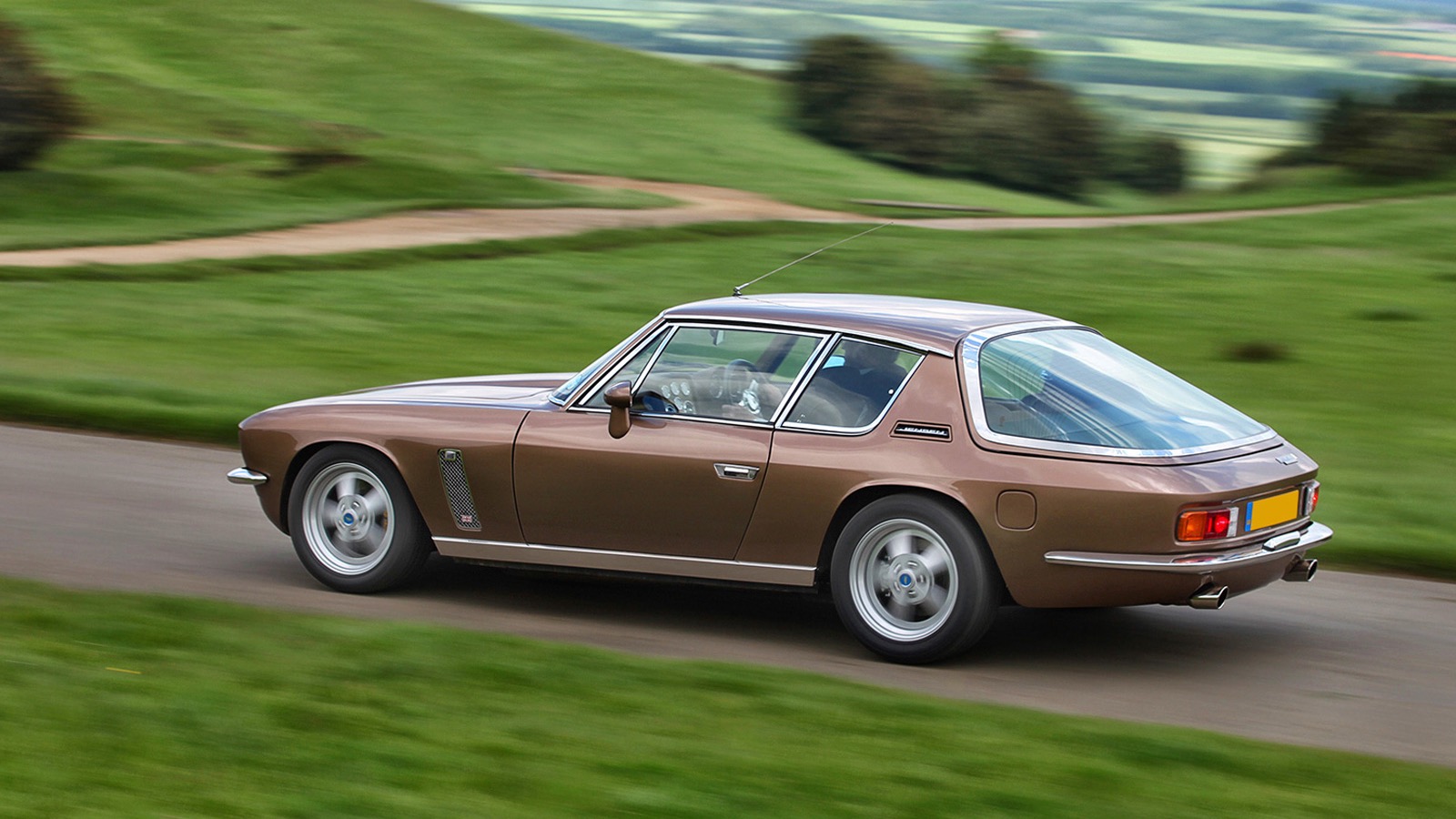 Rear quarter view of Jensen International Automotive Interceptor restomod in tan.