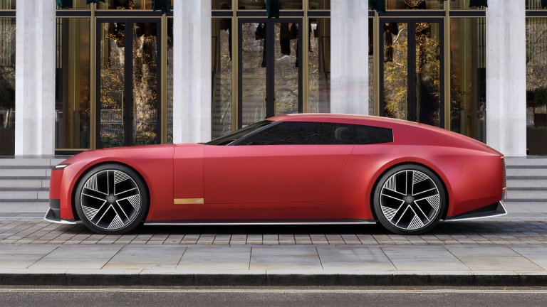Jaguar Type 00 concept in red, side profile, outside a hotel