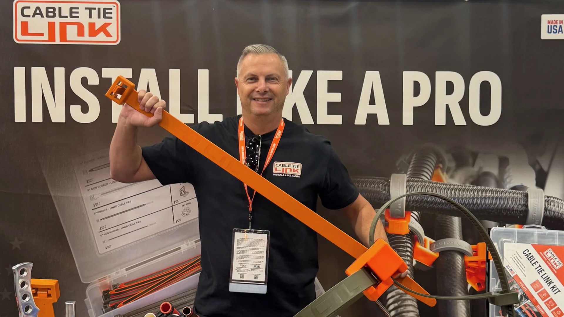 Trade show attendee holding a giant zip tie.