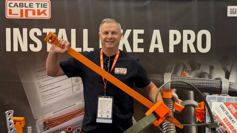 Trade show attendee holding a giant zip tie.