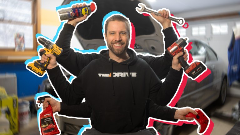 The Drive's garage; site Executive Editor holding a range of tools.