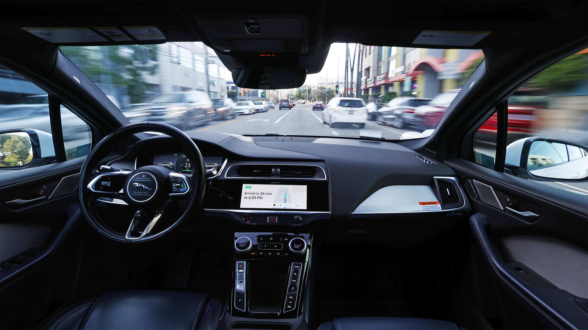 Interior view of a driverless self-driving vehicle as it drives on a road.