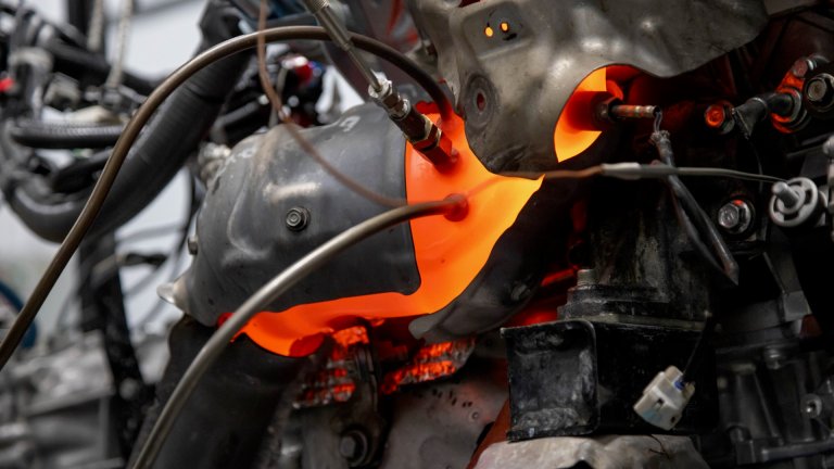 A Nissan V6 glows orange during a dyno test.