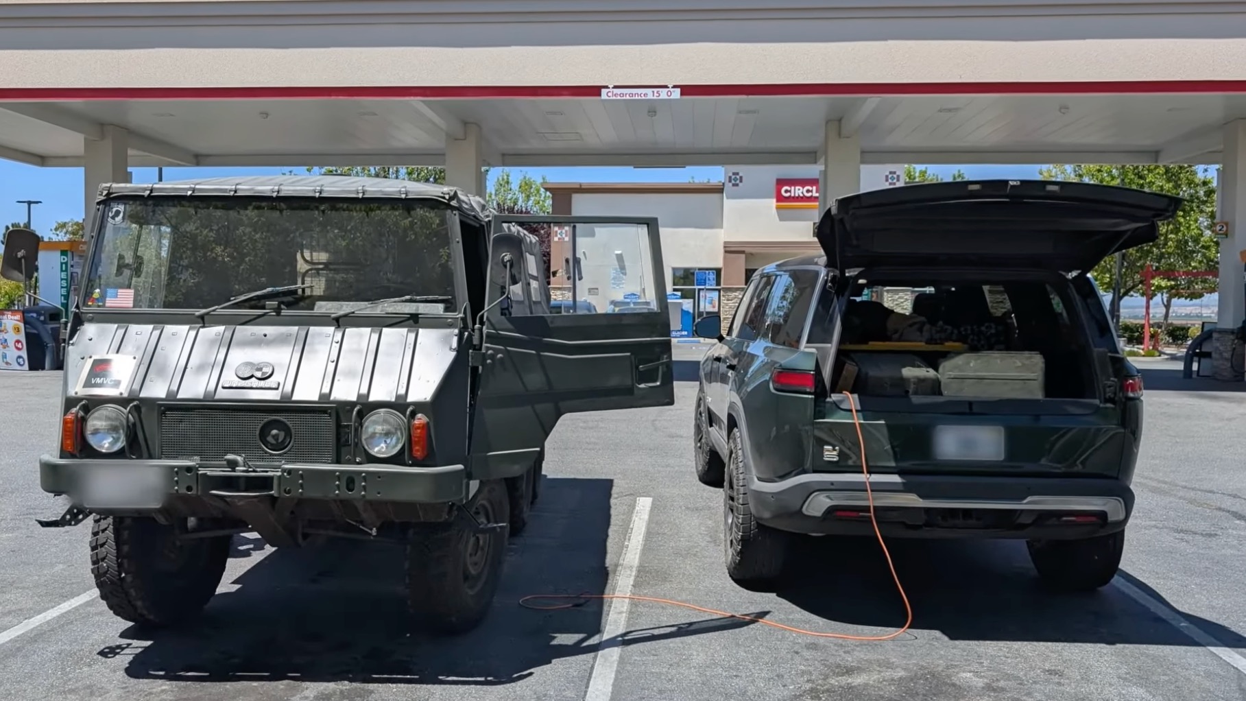 Pinzgauer EV conversion getting a charge from a Rivian R1S.