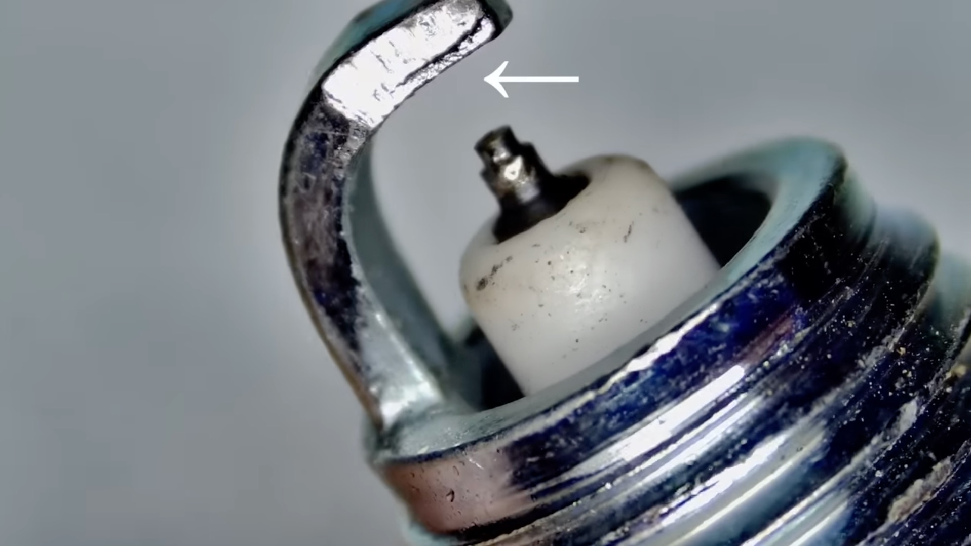 Poorly-manufactured strap on knockoff spark plug.