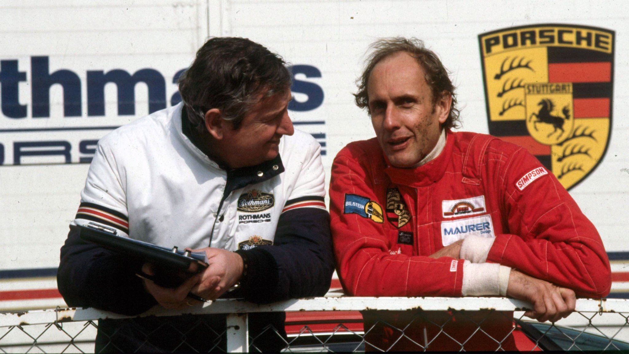 Hans-Joachim Stuck, at right, talks with Porsche engineer Norbert Singer.