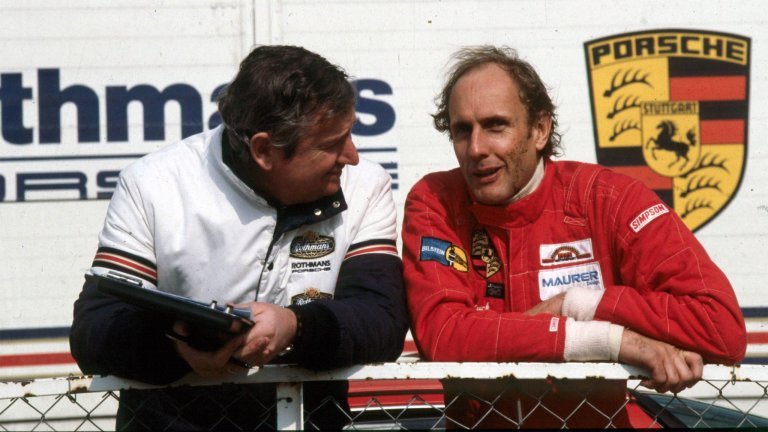 Hans-Joachim Stuck, at right, talks with Porsche engineer Norbert Singer.