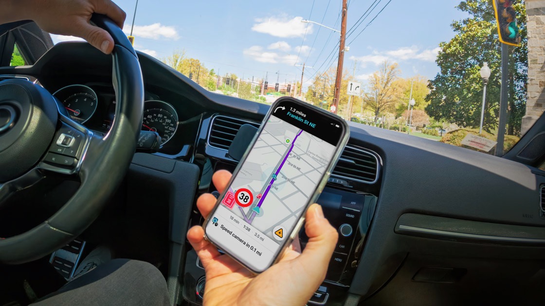 Person holding a phone while driving