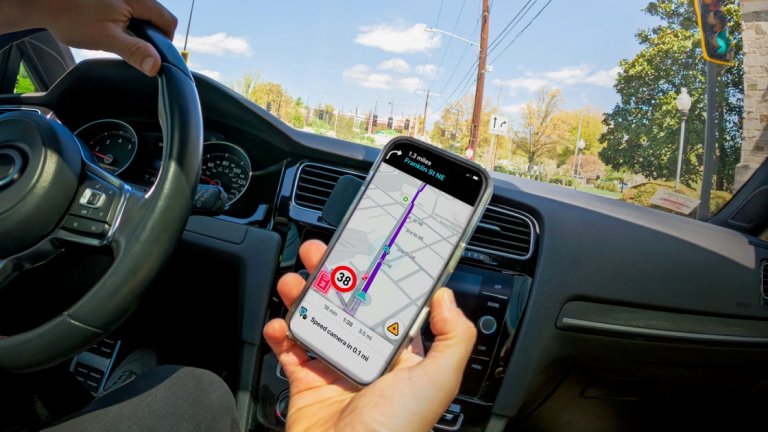 Person holding a phone while driving