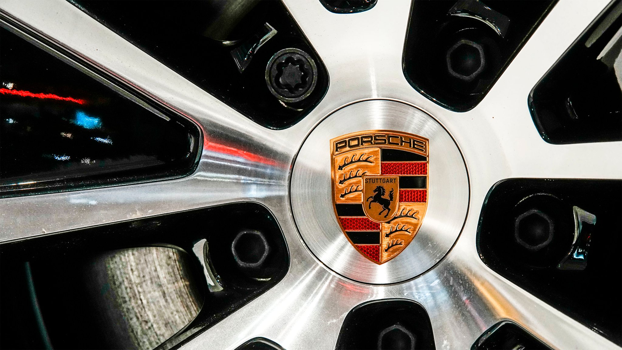 The logo of car manufacturer Porsche is seen on the wheel rim at the New York Auto Show.