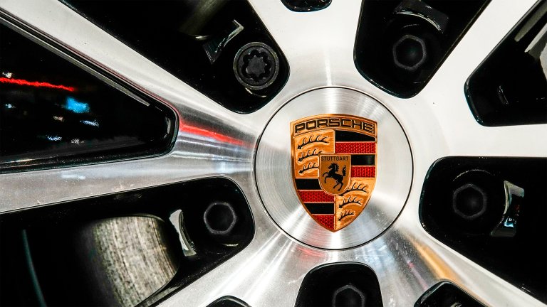 The logo of car manufacturer Porsche is seen on the wheel rim at the New York Auto Show.