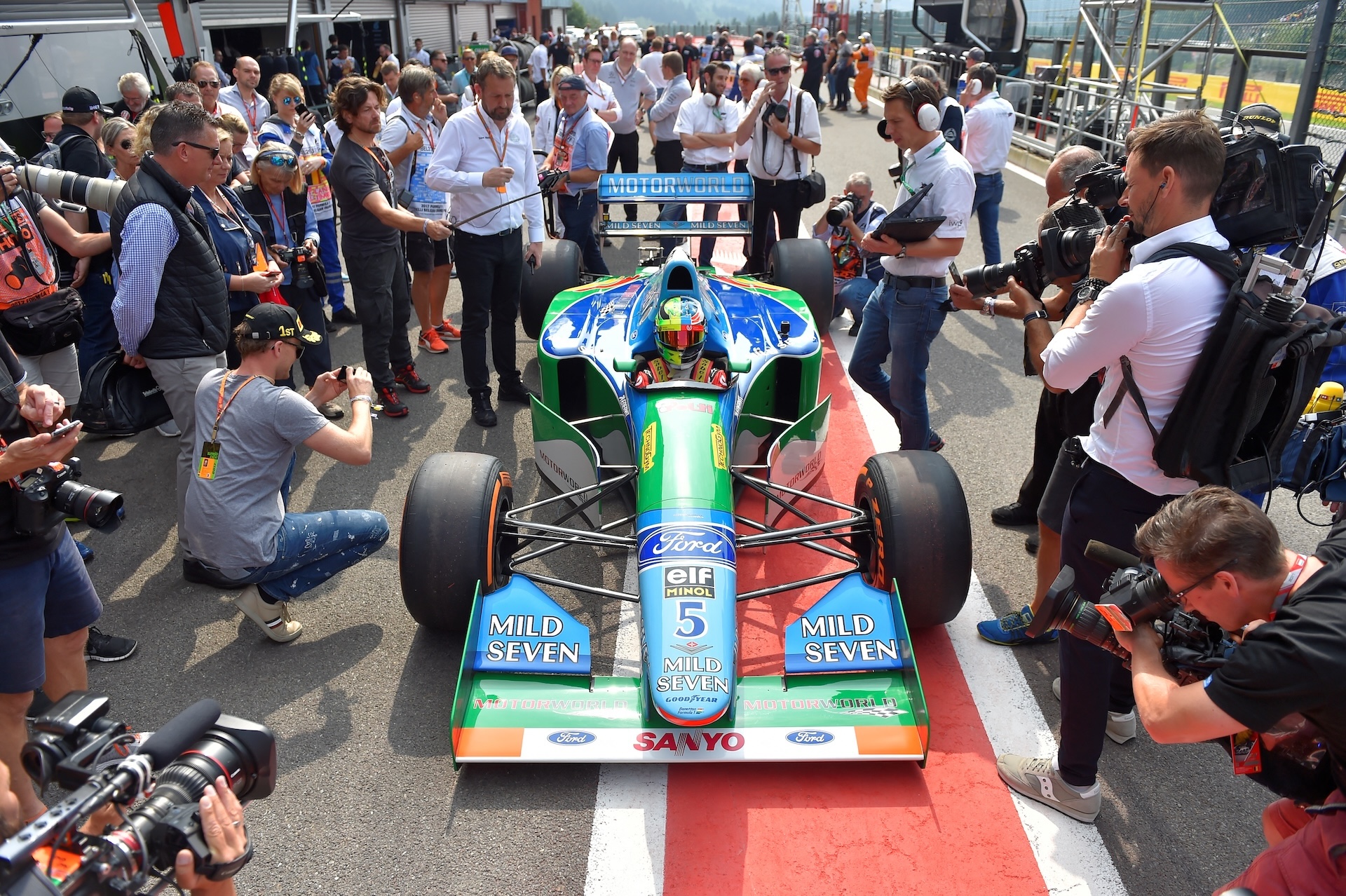 Mick Schumacher, German racing driver and son of seven-time Formula One champion Michael Schumacher, sits inside a Benetton B194 car before driving demonstration laps on the occasion of Michael Schumacher's 25th first Formula One victory, at the Spa-Francorchamps circuit in Spa on August 27, 2017, ahead of the Belgian Formula One Grand Prix. (Photo by LOIC VENANCE / AFP)