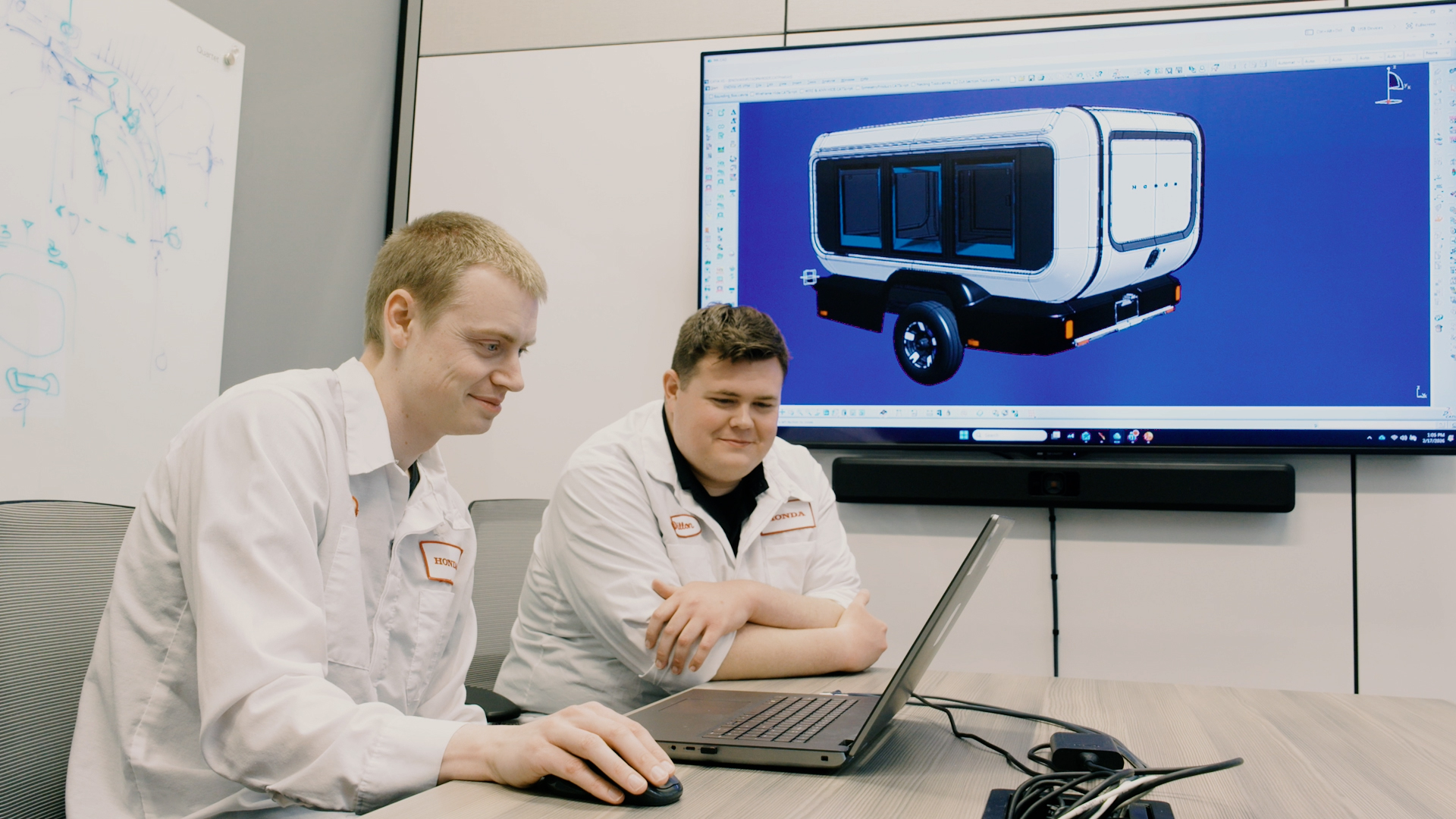 Designers at Honda Development & Manufacturing of America evaluating a CAD model of the Base Station prototype.