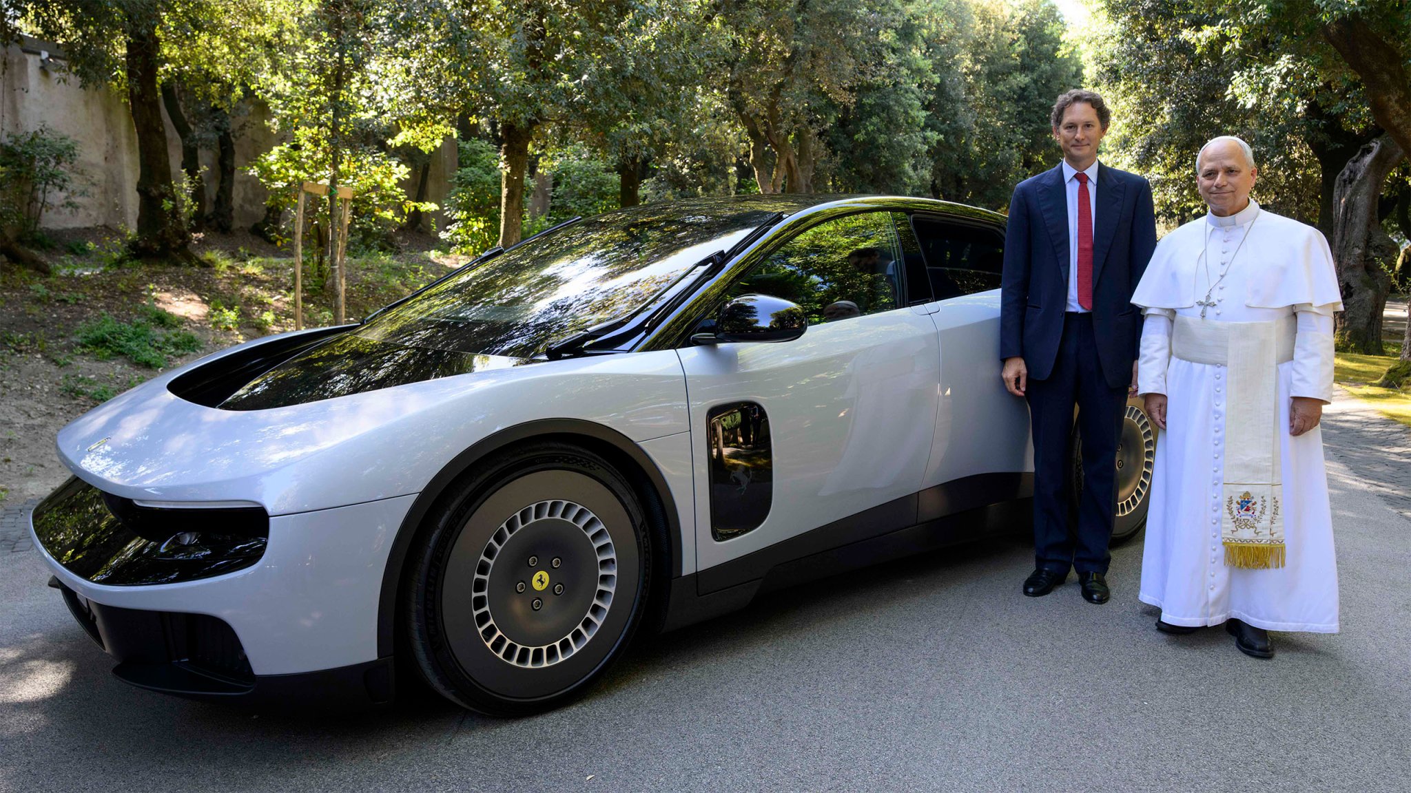 Pope Leo XIV and Ferrari Chairman John Elkann pose beside the Ferrari Luce on May 26.