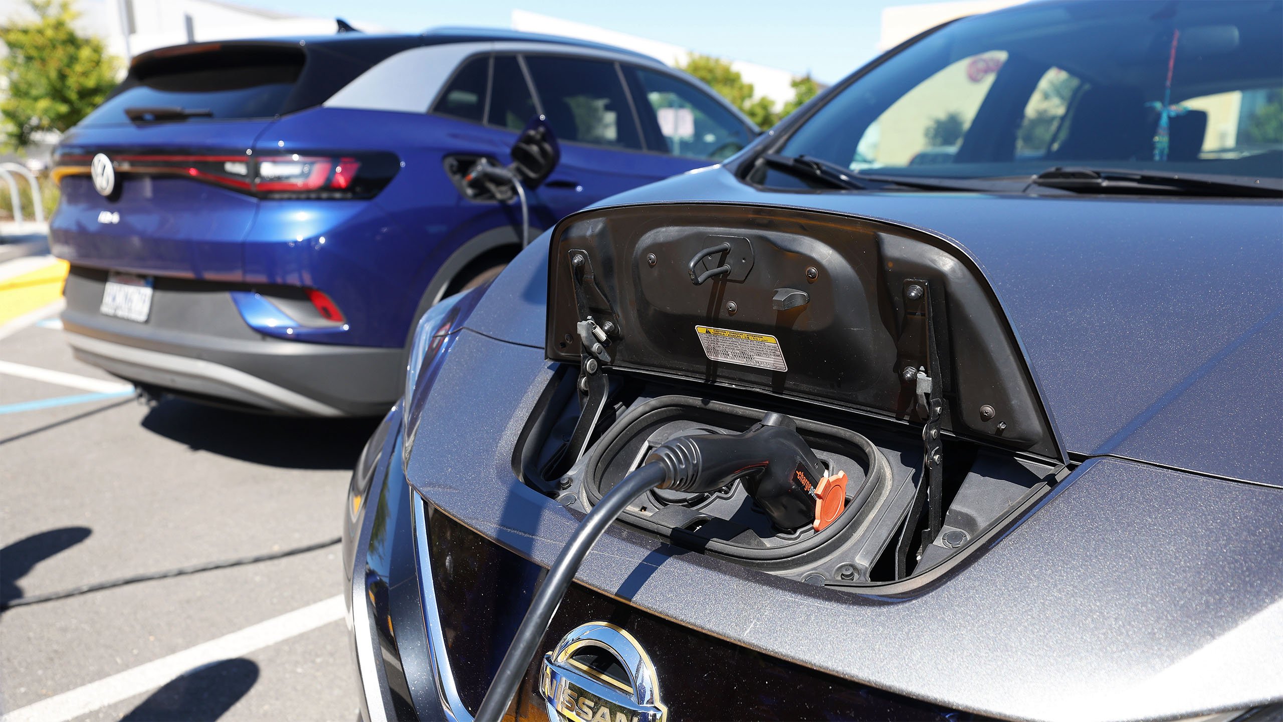 Two EVs charging at a public charger