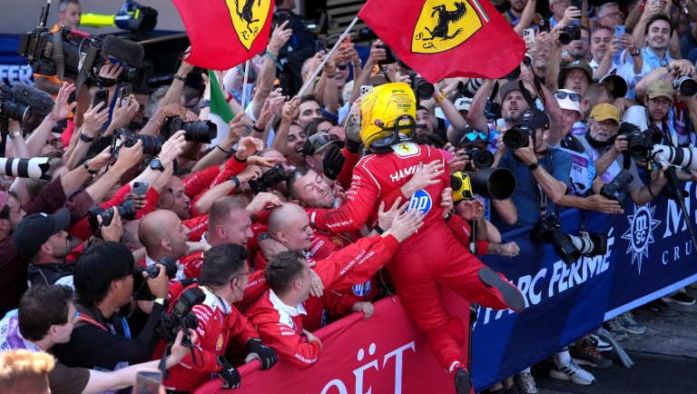 Winner Ferrari's British driver Lewis Hamilton celebrates with his team after the Catalonia Formula One Grand Prix at the Circuit de Catalunya in Montmelo, on the outskirts of Barcelona, on June 14, 2026. (Photo by Manaure QUINTERO / AFP)
