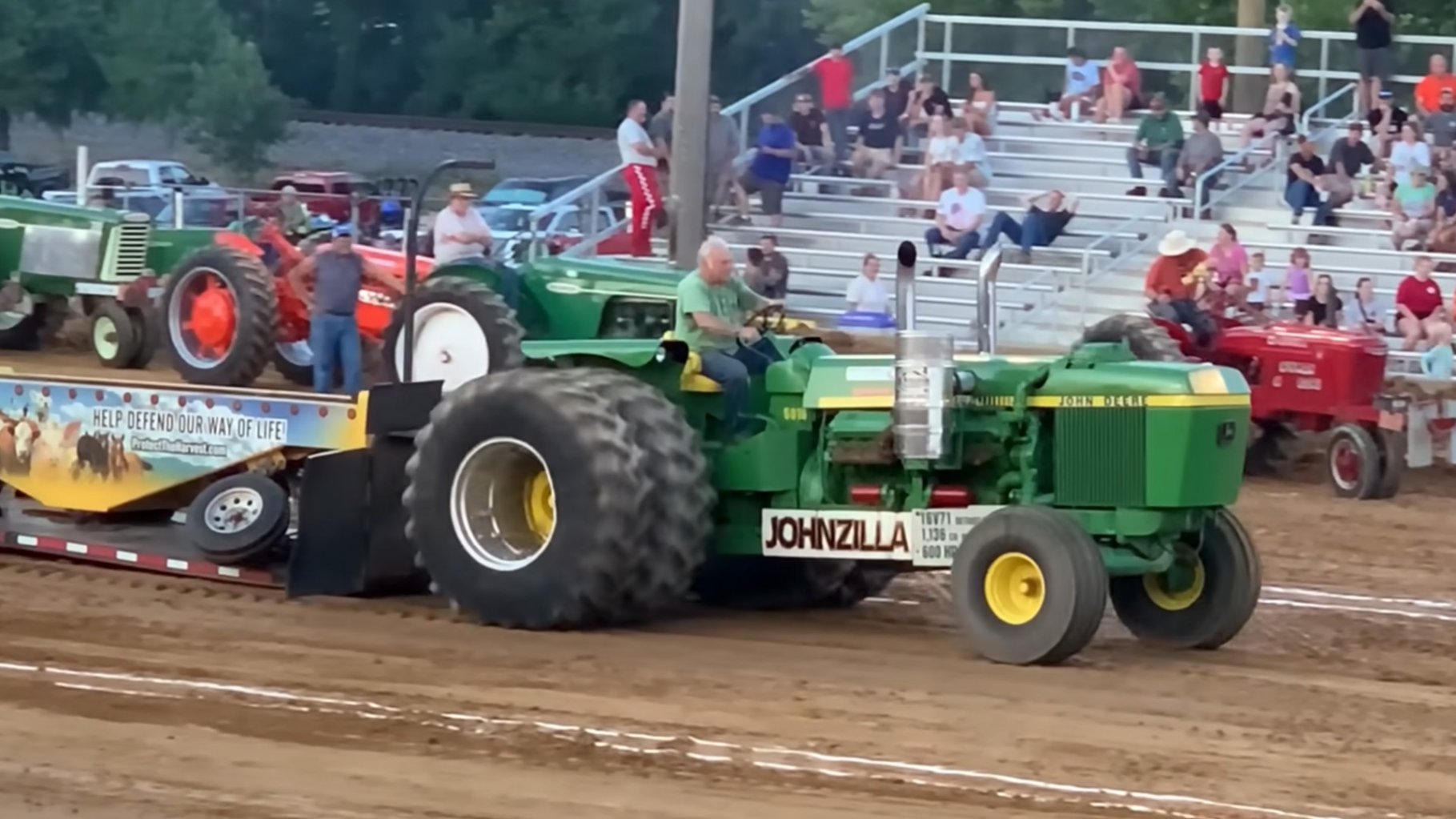 John Deere tractor with V16 Detroit Diesel engine pulling a sled