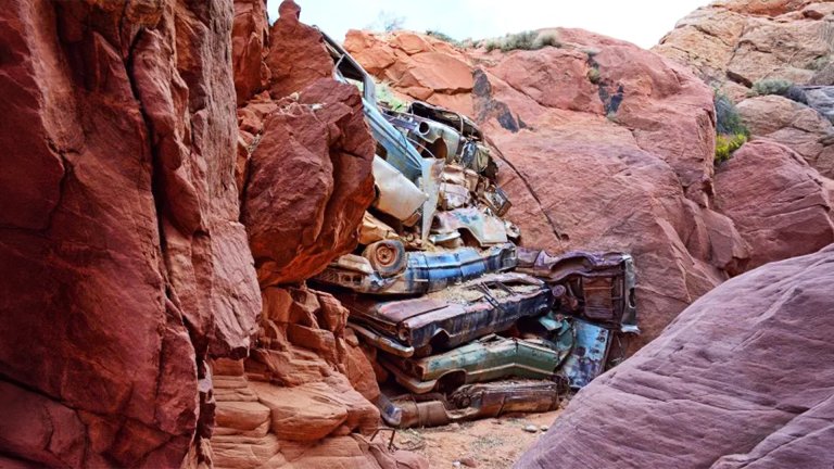 old cars piled in a canyon in utah