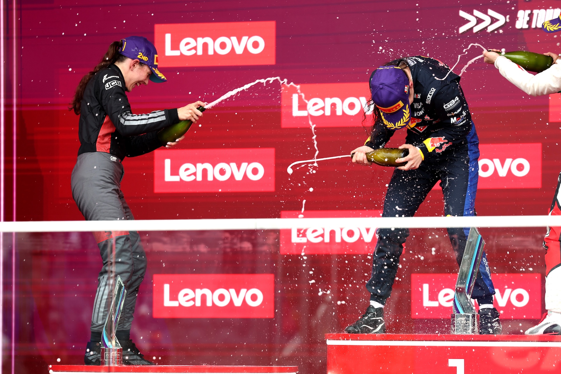MONTREAL, QUEBEC - MAY 24: Race winner Alisha Palmowski of Great Britain and Campos Racing (21) and Second placed Emma Felbermayr of Austria and Rodin Motorsport (5) and Audi F1 Team celebrate with Champagne on the podium during F1 Academy Round 2, race 3 at Circuit Gilles Villeneuve on May 24, 2026 in Montreal, Quebec. (Photo by Brett Farmer/LAT Images)