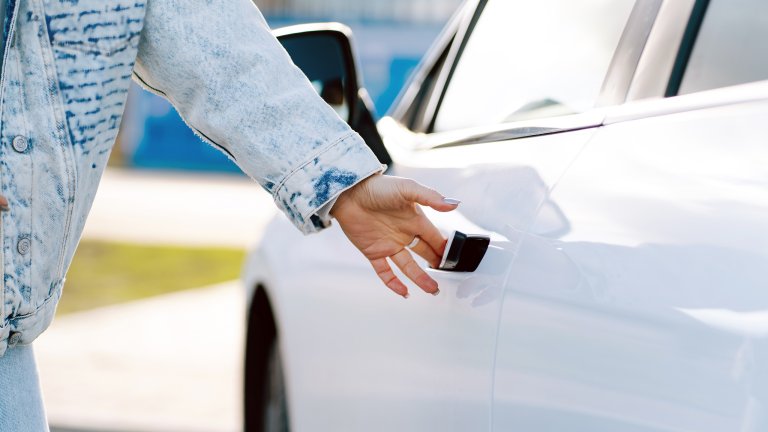 Someone opening electric car door handle