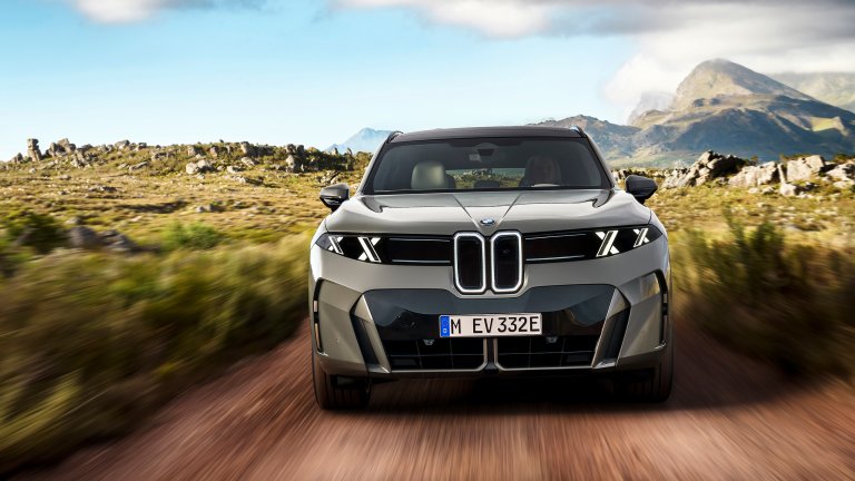 BMW X5 driving off road toward camera
