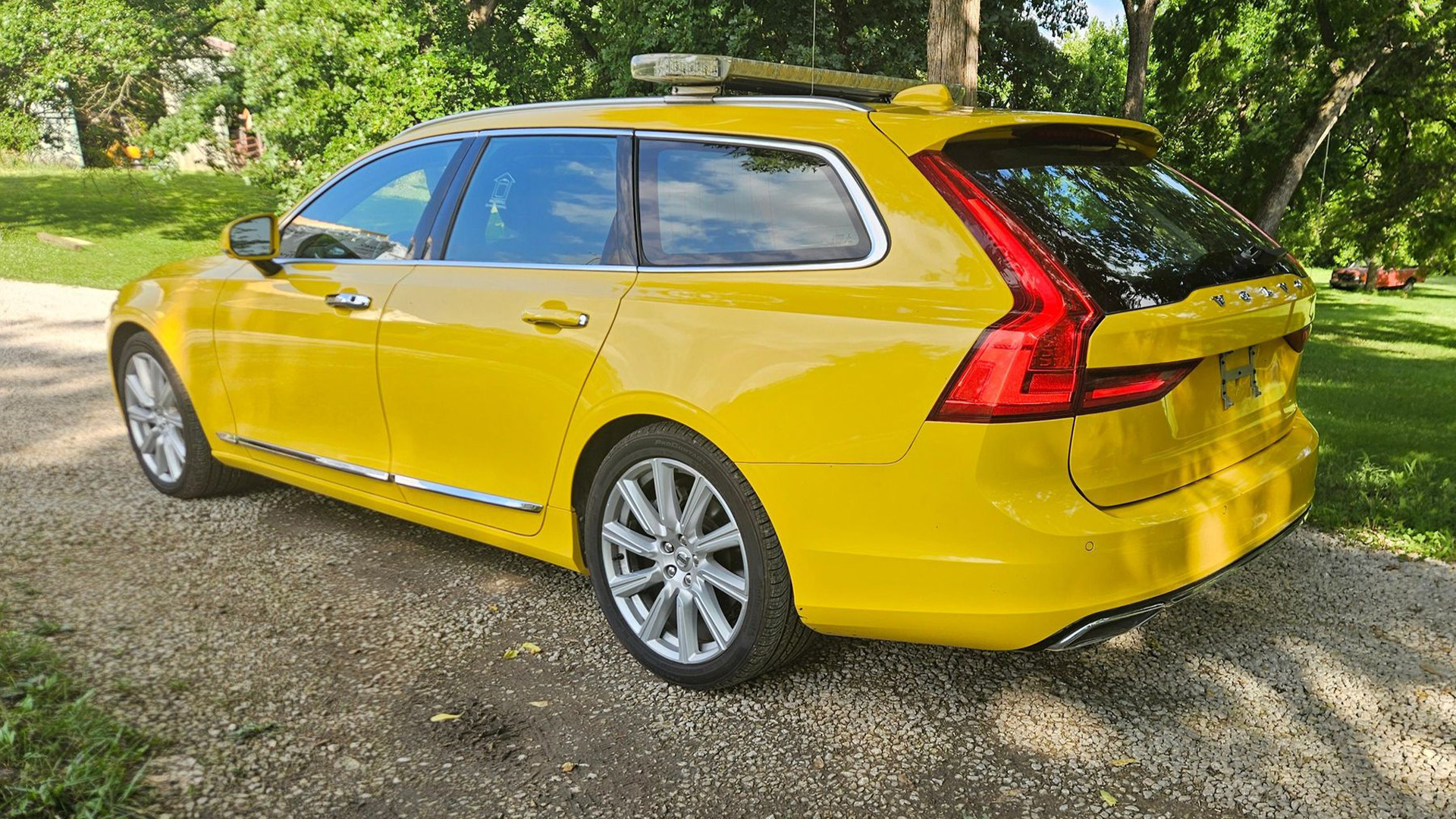 Yellow Volvo V90 with SARSYS airport runway friction testing equipment