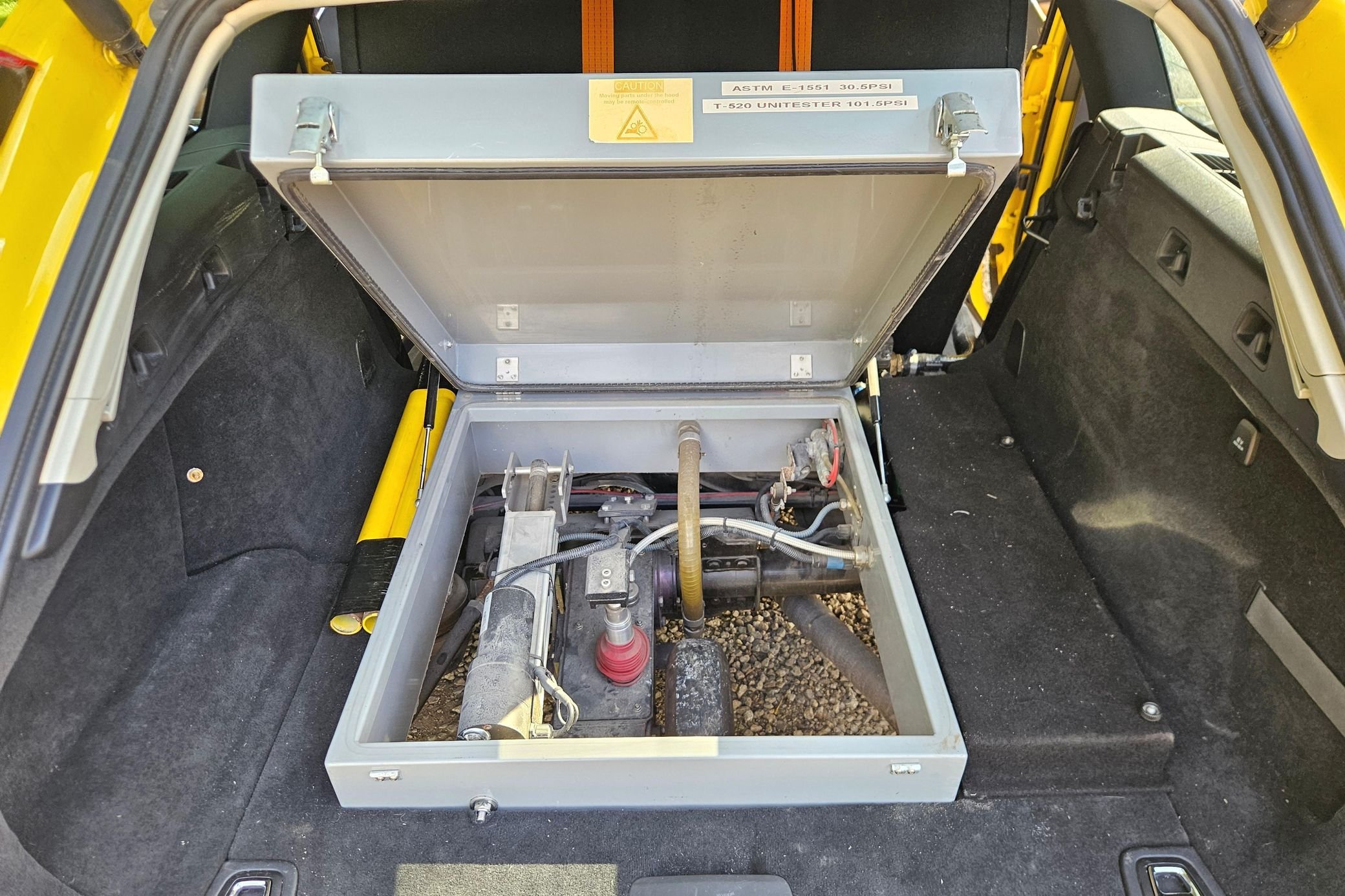 Yellow Volvo V90 with SARSYS airport runway friction testing equipment