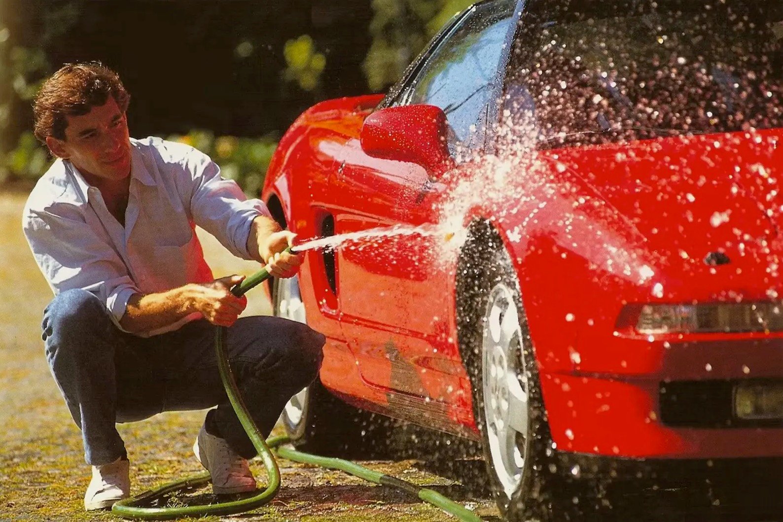 Ayrton Senna is pictured washing the NSX in a timeless shot.