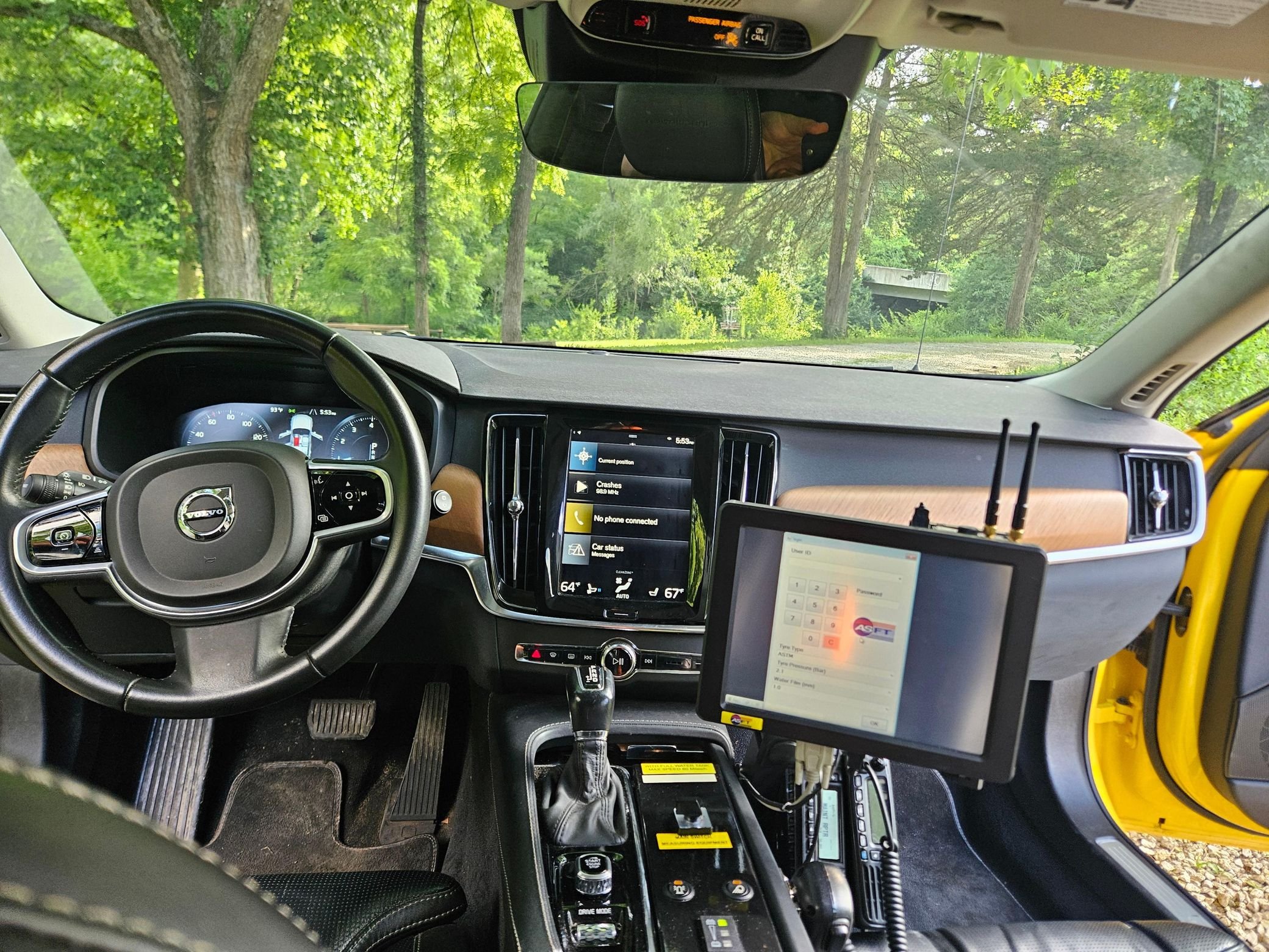 Yellow Volvo V90 with SARSYS airport runway friction testing equipment