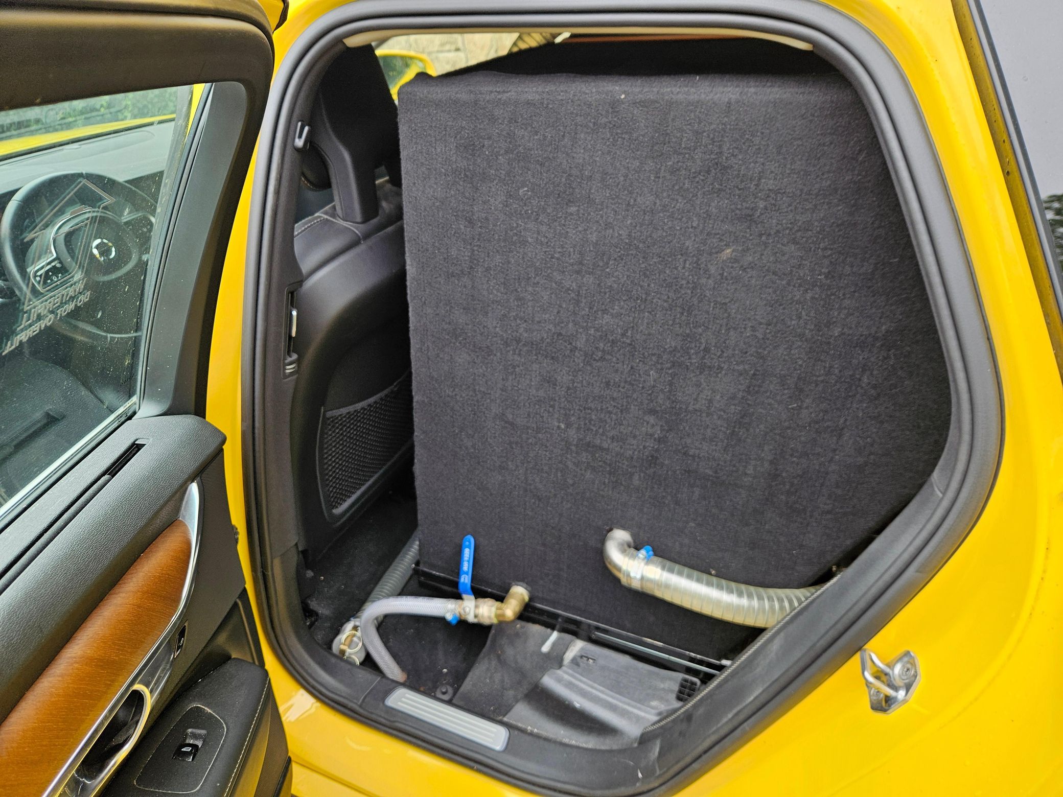 Yellow Volvo V90 with SARSYS airport runway friction testing equipment