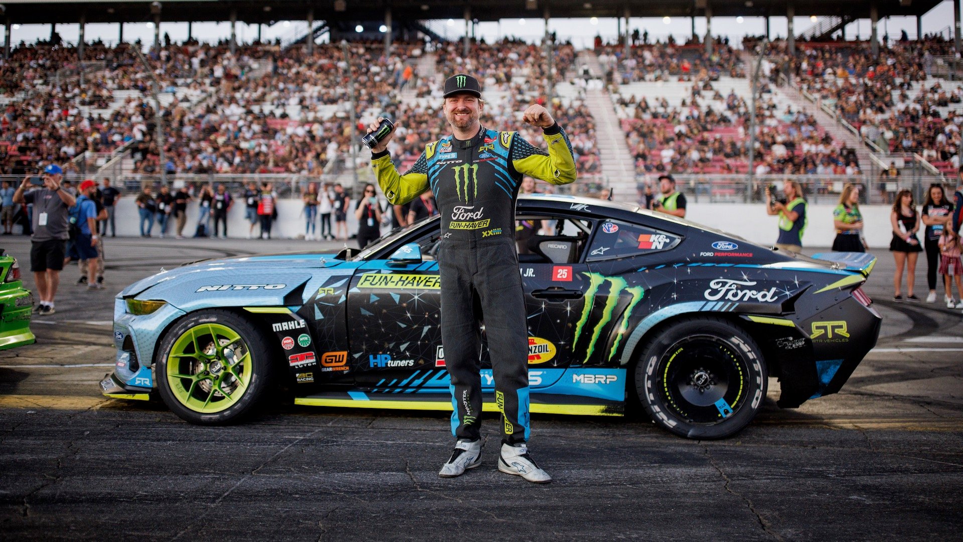 Vaughn Gittin Jr. poses with his Ford Mustang drift car
