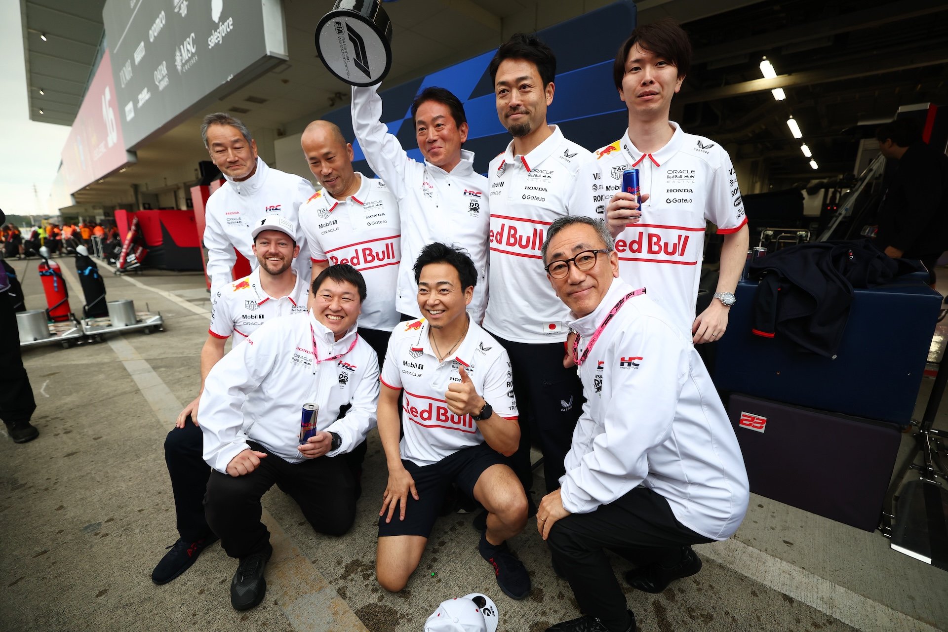 SUZUKA, JAPAN - APRIL 06: Koji Watanabe, President of Honda Racing Corporation and Oracle Red Bull Racing and Honda team members celebrate with the trophy during the F1 Grand Prix of Japan at Suzuka Circuit on April 06, 2025 in Suzuka, Japan. (Photo by Mark Thompson/Getty Images)