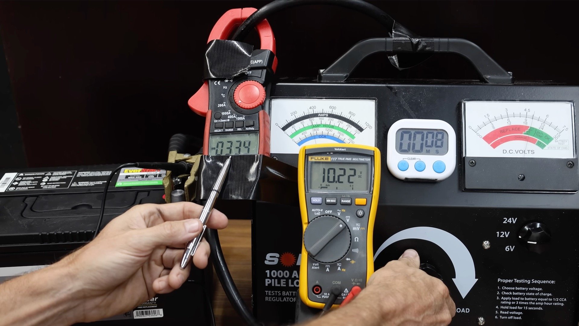 Car battery hooked up to testing equipment