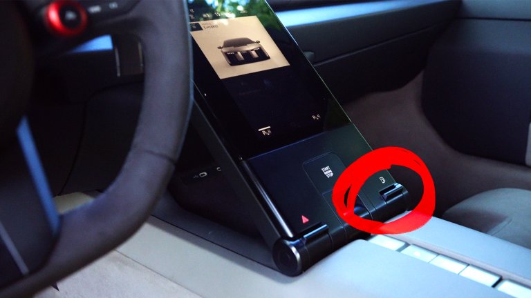 Close-up of the Audi Nuvolari's fuel door button near the center console, highlighted with a red circle.