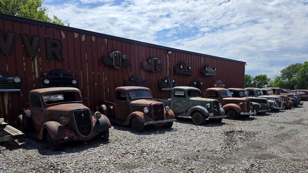 line of old trucks headed to auction