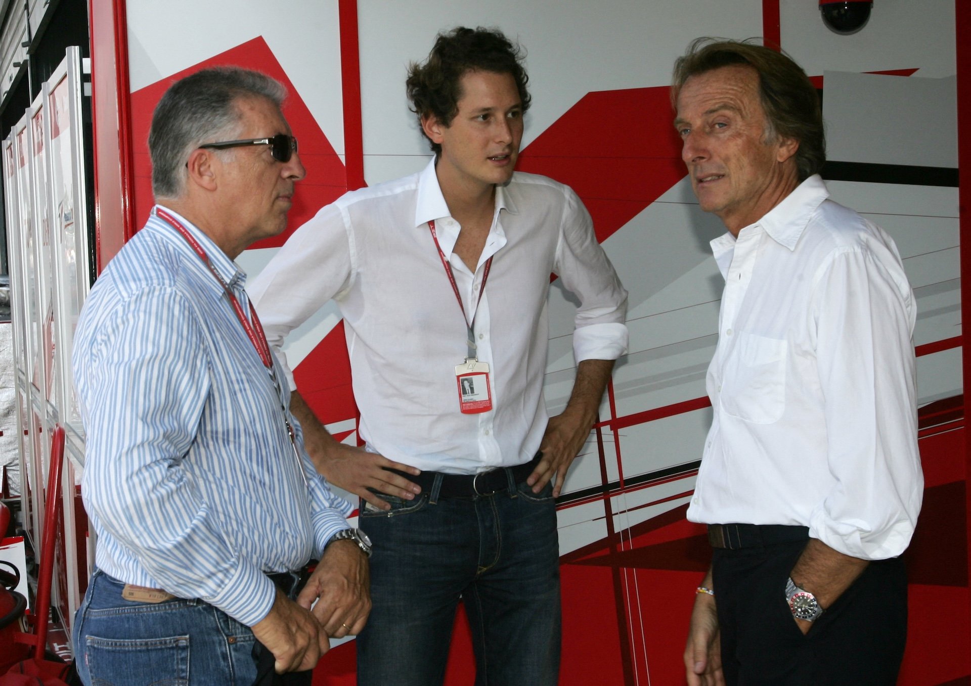 (L to R) Piero Ferrari, son of Enzo Ferrari, John Elkan, nefiew of Enzo Ferrari, and Ferrari President Luca Cordero di Montezemolo chat in the pits of the Monza racetrack during the Italian Formula One Grand prix, 10 September 2006 in Monza. German Ferrari driver Michael Schumacher won the race ahead of Finnish McLaren-Mercedes driver Kimi Raikkonen and Polish BMW Sauber driver Robert Kubica. AFP PHOTO POOL PATRICK HERTZOG (Photo by PATRICK HERTZOG / POOL / AFP)