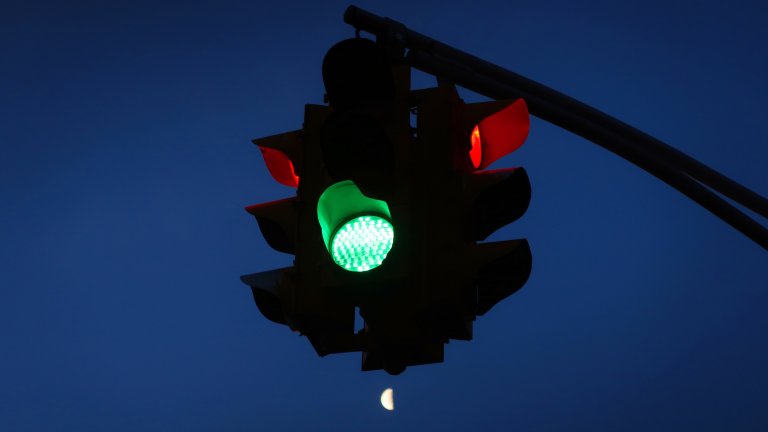 HOBOKEN, NJ - MARCH 9: The moon rises below a traffic light at sunrise on March 9, 2018 in Hoboken, New Jersey.