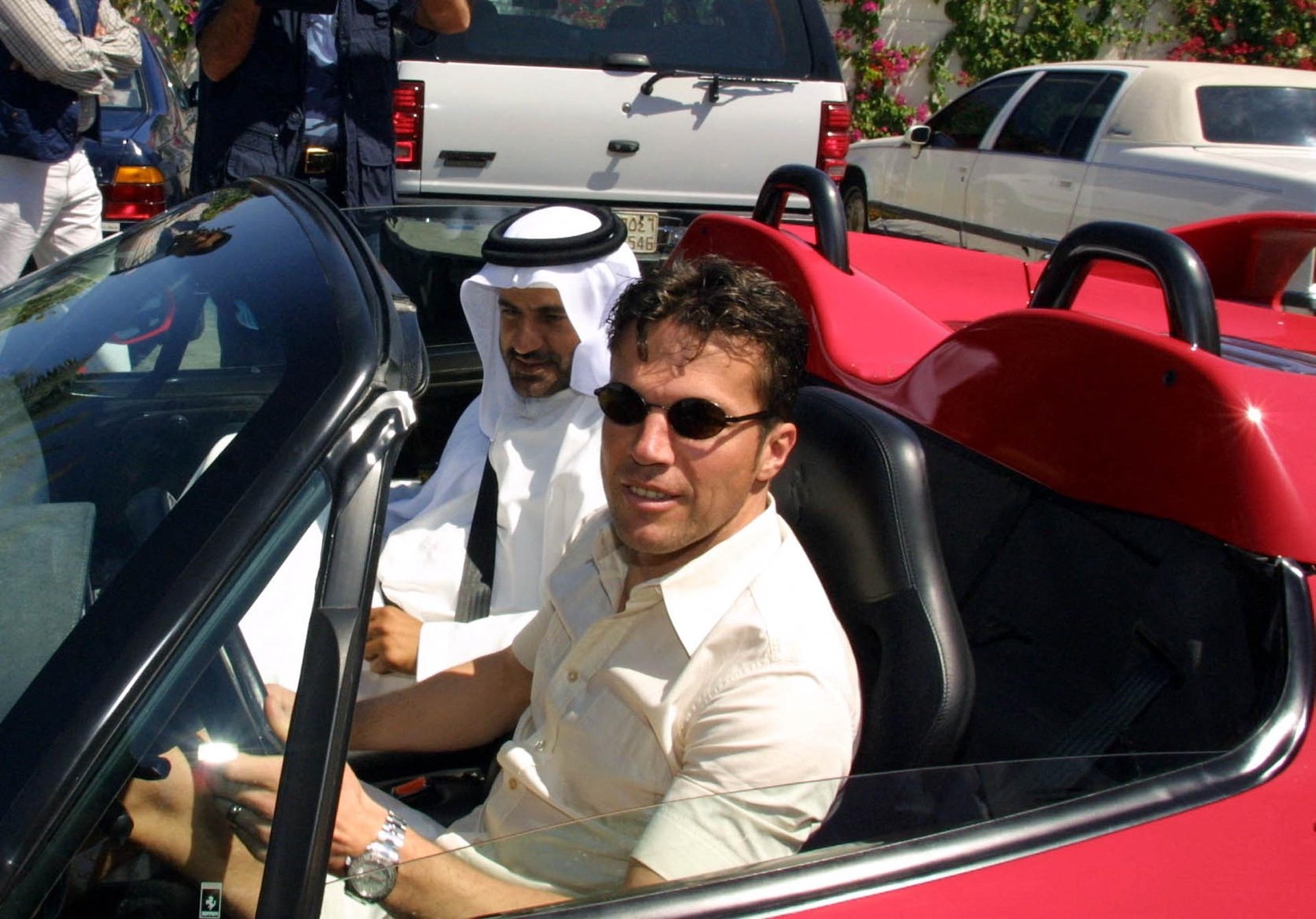 German soccer star Lothar Matthaeus (R) drives one of Emirati Middle East rally champion Mohammed Ben Sulayem's cars, during a tour at Sulayem's house in Dubai 07 March 2001. Mattaus is in Dubai to participate in a friendly game with Emirati al-Nasr club against Iran's Istiklal club. AFP PHOTO/Rabih MOGHRABI (Photo by RABIH MOGHRABI / AFP)