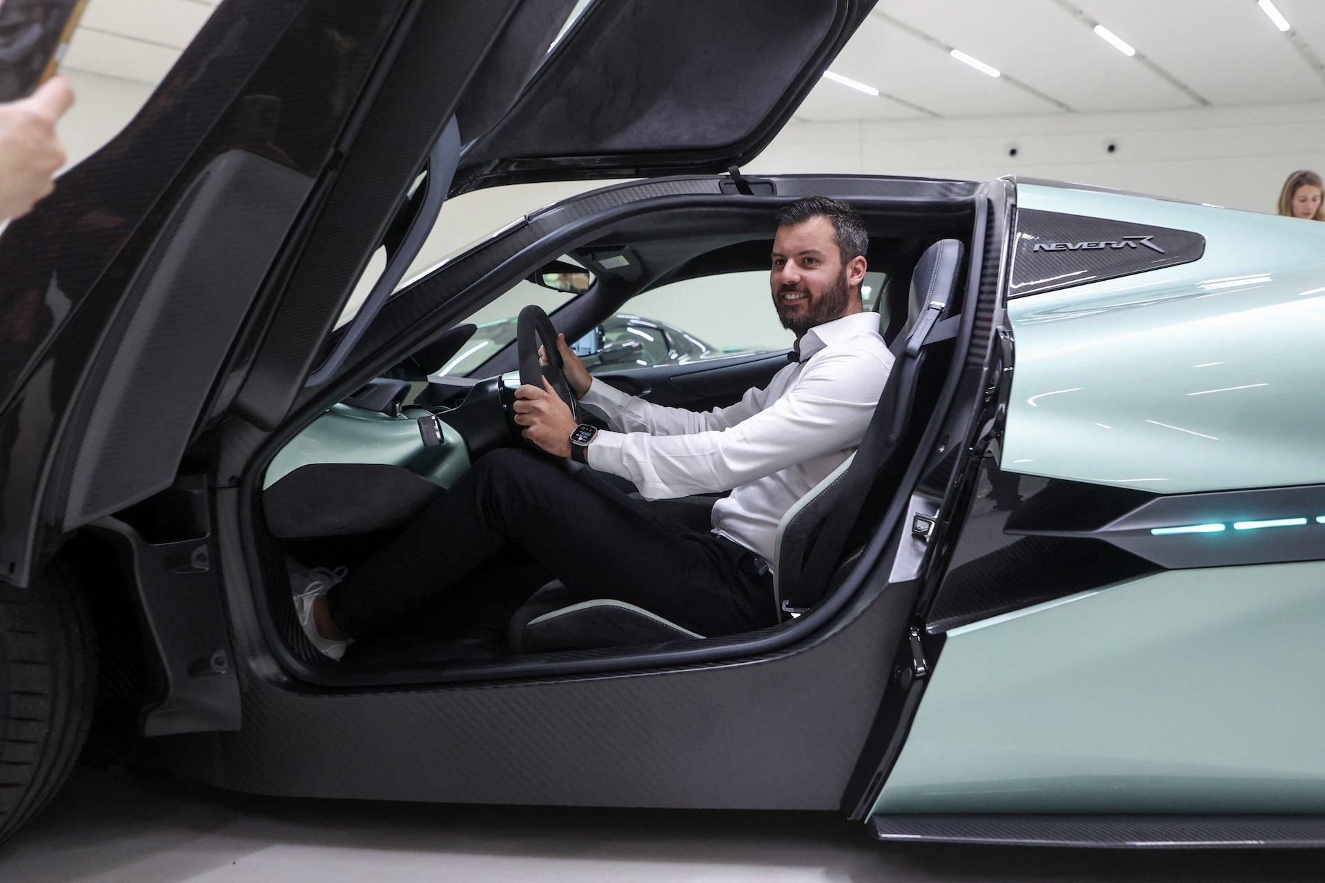 Bosnian entrepreneur Mate Rimac, owner of Croatia's Rimac Automobili Company, poses sitting in to the new Nevera R electric supercar with over 2100 horsepower, during a presentation on the sideline of the opening of the new Campus production plant in Kerestinec, few kilometres west of Zagreb, on October 17, 2024. (Photo by DAMIR SENCAR / AFP)
