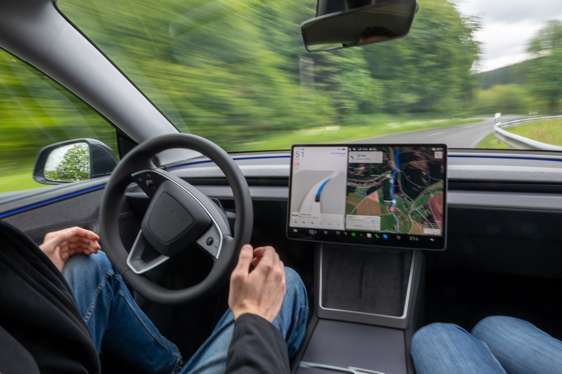 11 May 2026, Rhineland-Palatinate, Gerolstein: A self-driving Tesla Model Y is driving autonomously on the roads of the Eifel. A factory driver sitting at the wheel intervenes as required in the "Full Self-Driving" (FSD/Supervised) software update, which is not yet approved nationwide. Photo: Harald Tittel/dpa (Photo by Harald Tittel/picture alliance via Getty Images)