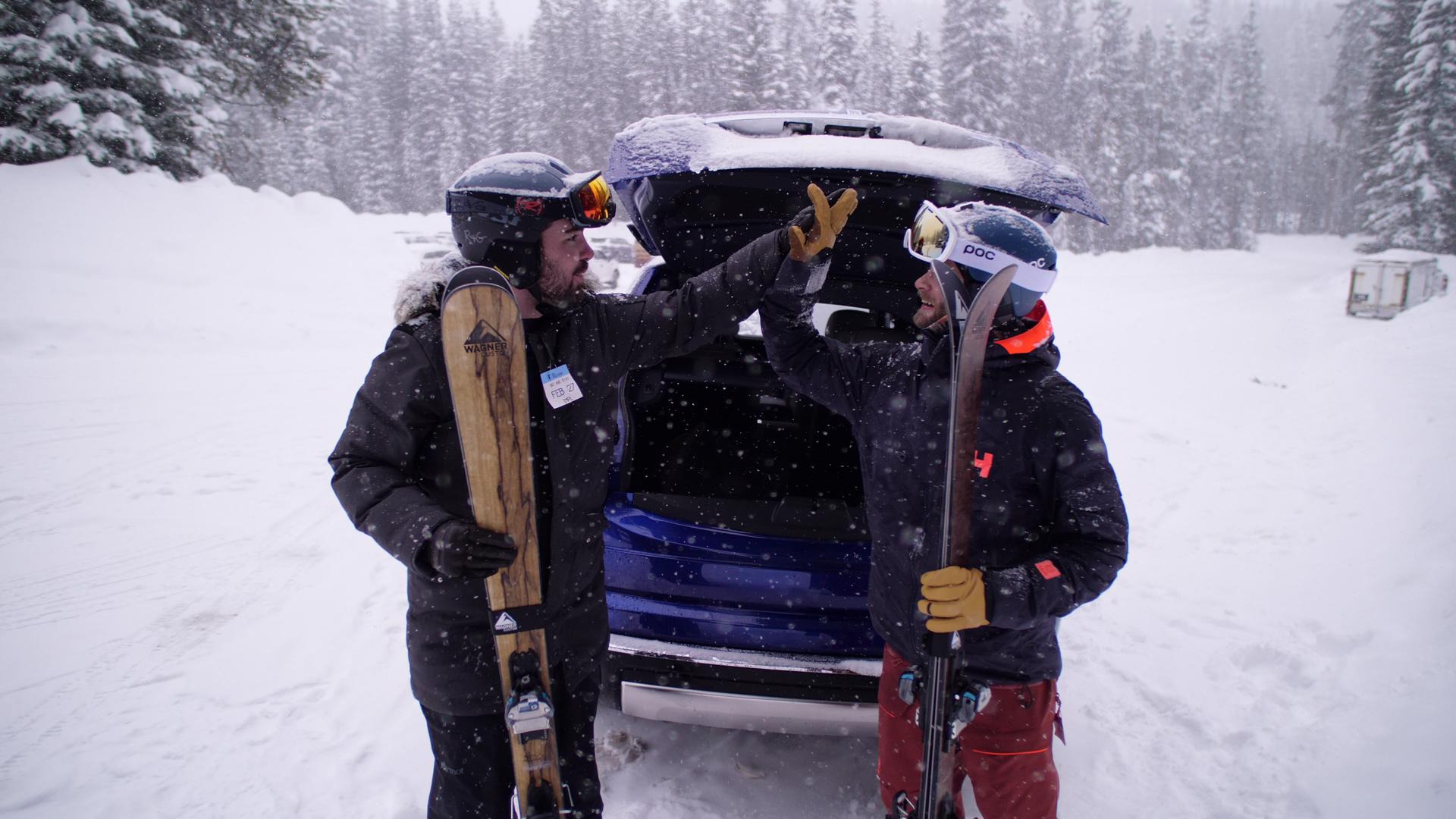 The author high-fiving his mate because they're driving a cool Rolls-Royce SUV. 