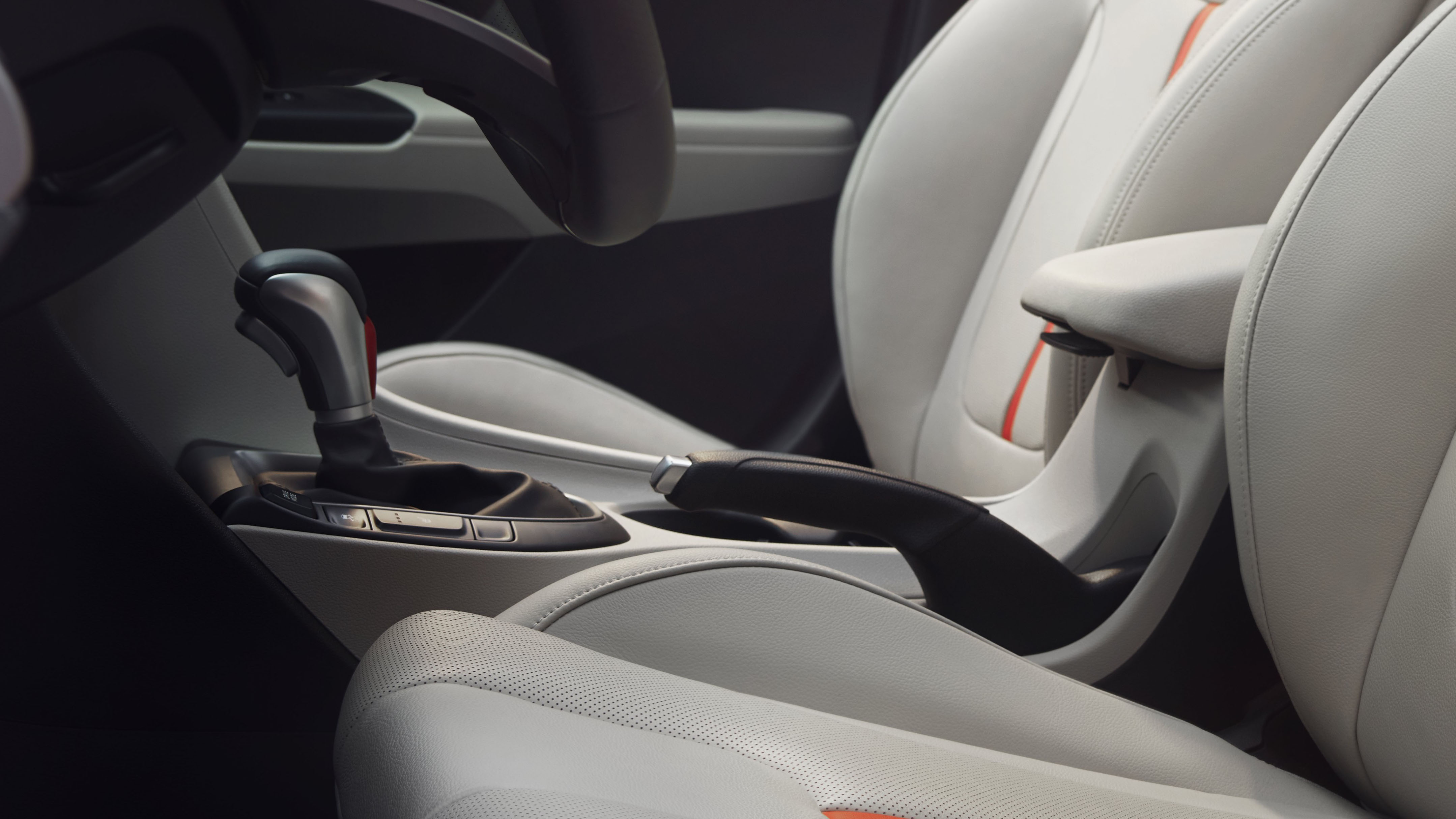 A mechanical parking brake in a light car interior.