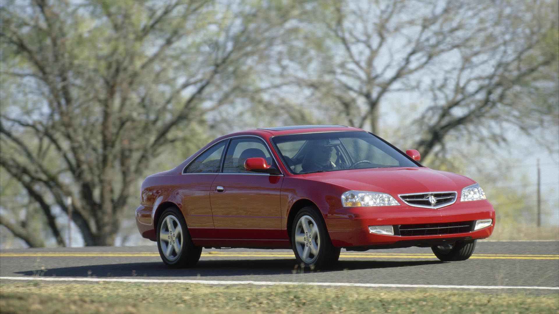 A red 2001 Acura 3.2CL Type S driving on the road.