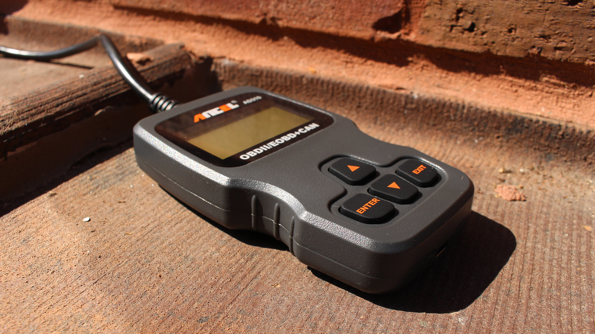 The Ancel AD310 OBD reader outside of its plastic packaging.