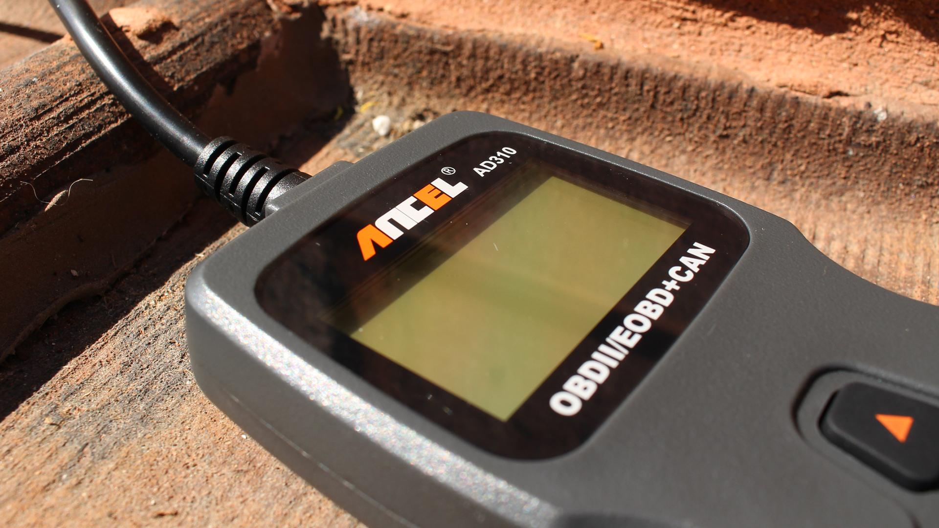 The Ancel AD310 OBD reader outside of its plastic packaging.