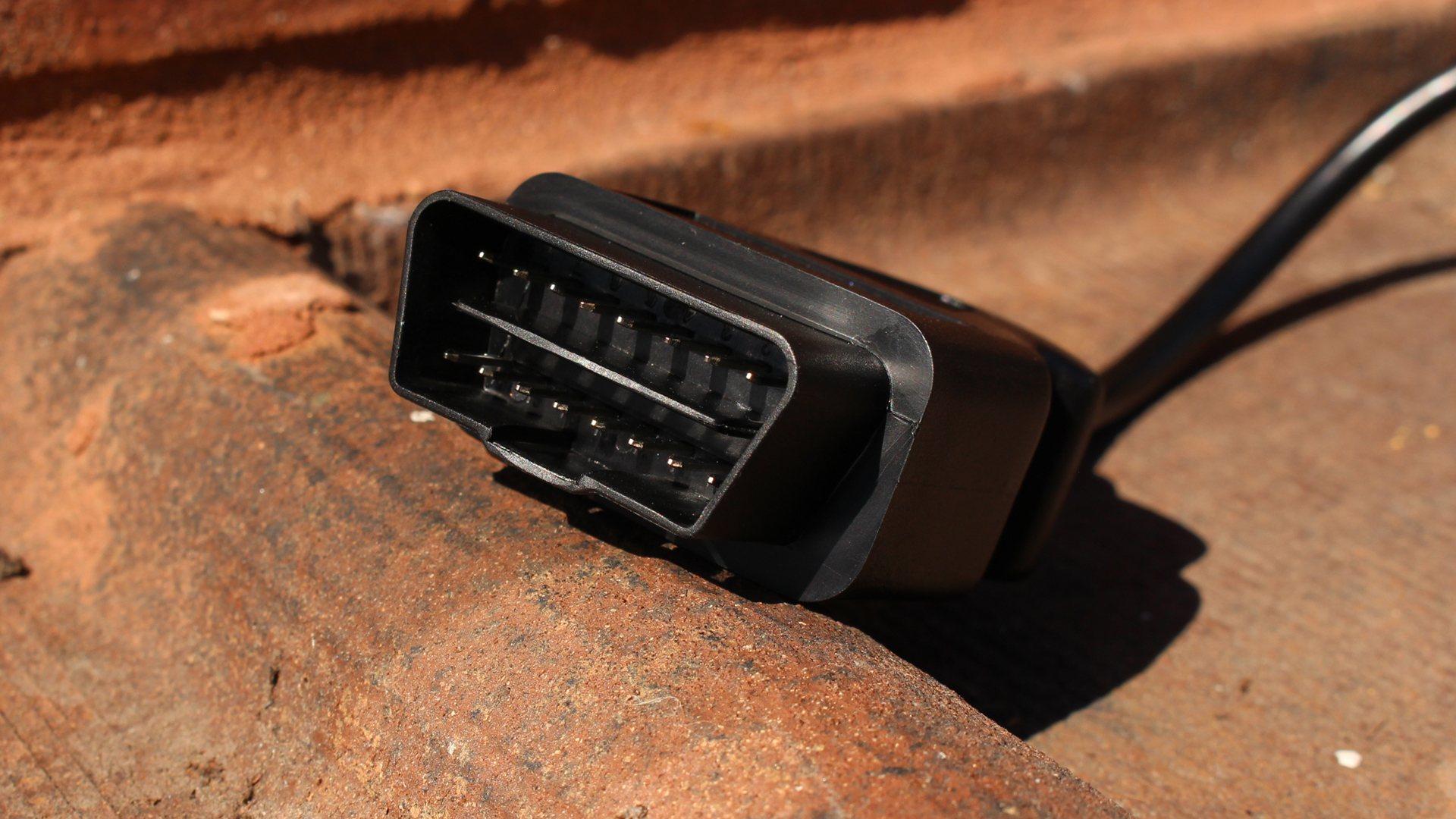 The plug of an Ancel AD310 OBD reader.